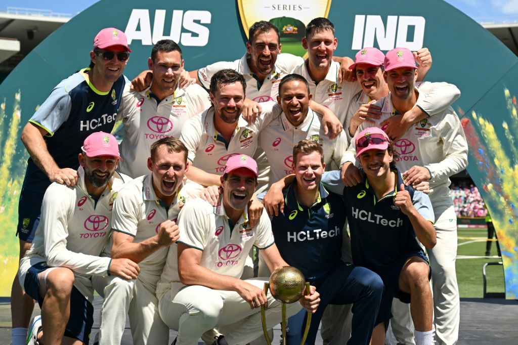 Australia players celebrate with the Border–Gavaskar Trophy after winning the fifth Test and the series 3-1 against India, AFP