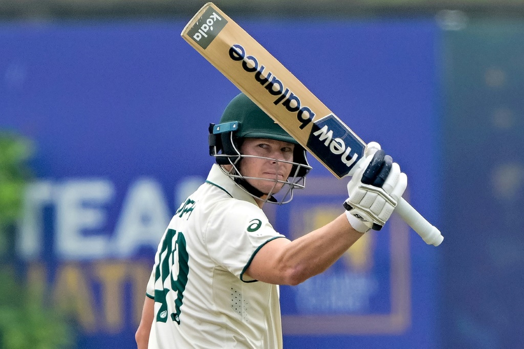 Australia's captain Steve Smith celebrates after scoring his 10,000 run. AFP