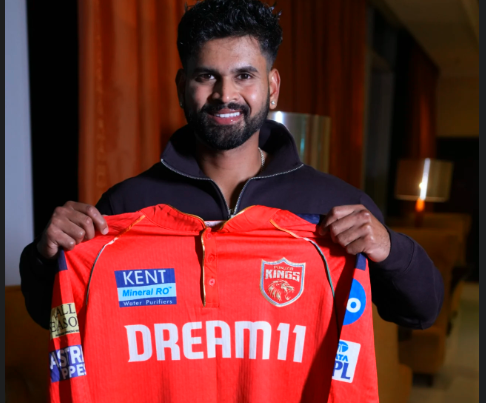 Shreyas Iyer holding PK's jersey