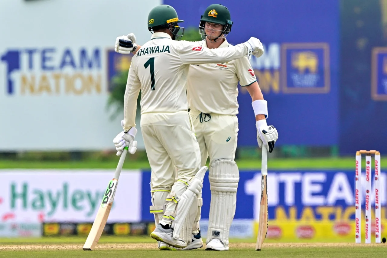 Usman Khawaja congratulates Steven Smith on joining the 10,000-run club, AFP