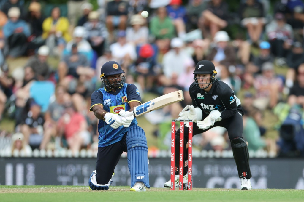 Sri Lanka's Kusal Perera plays a shot as New Zealand wicketkeeper Mitch Hay looks on during the third Twenty20, AFP