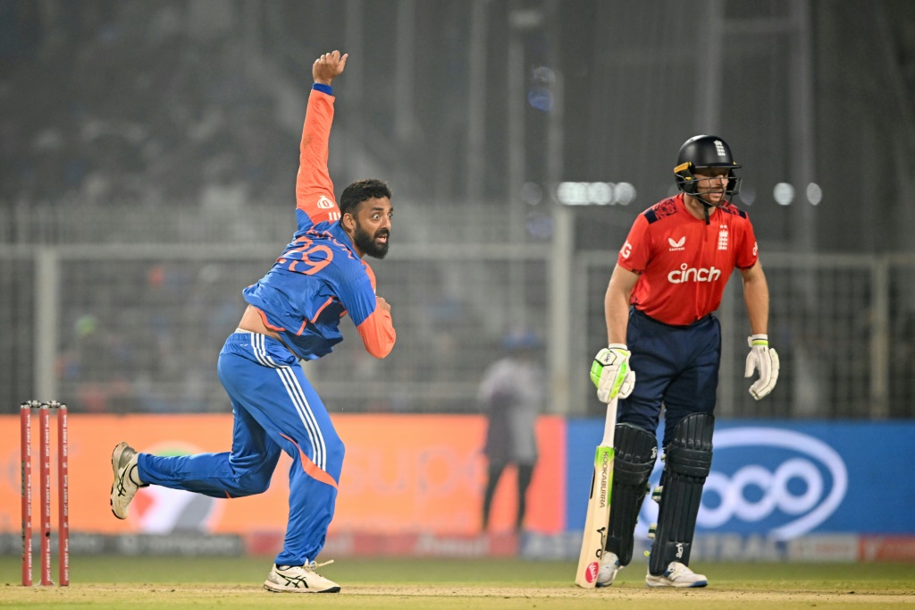 India's Varun Chakravarthy on his way to taking three wickets, including the crucial scalp of Jos Buttler (R), AFP