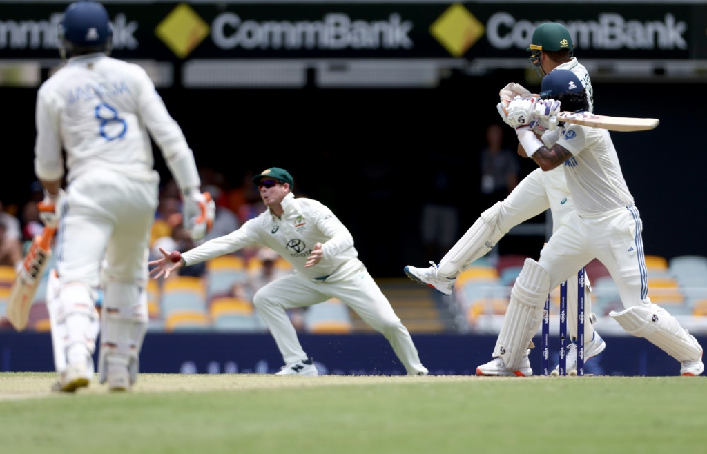 Steve Smith dives to his right to take a stunning catch and dismiss KL Rahul, AFP