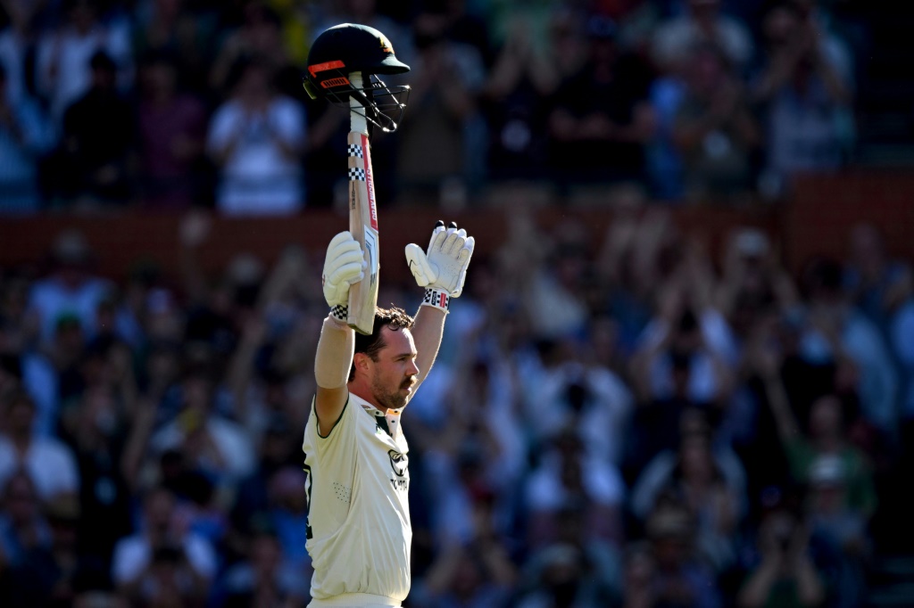 Travis Head celebrates after scoring a century against India,  AFP