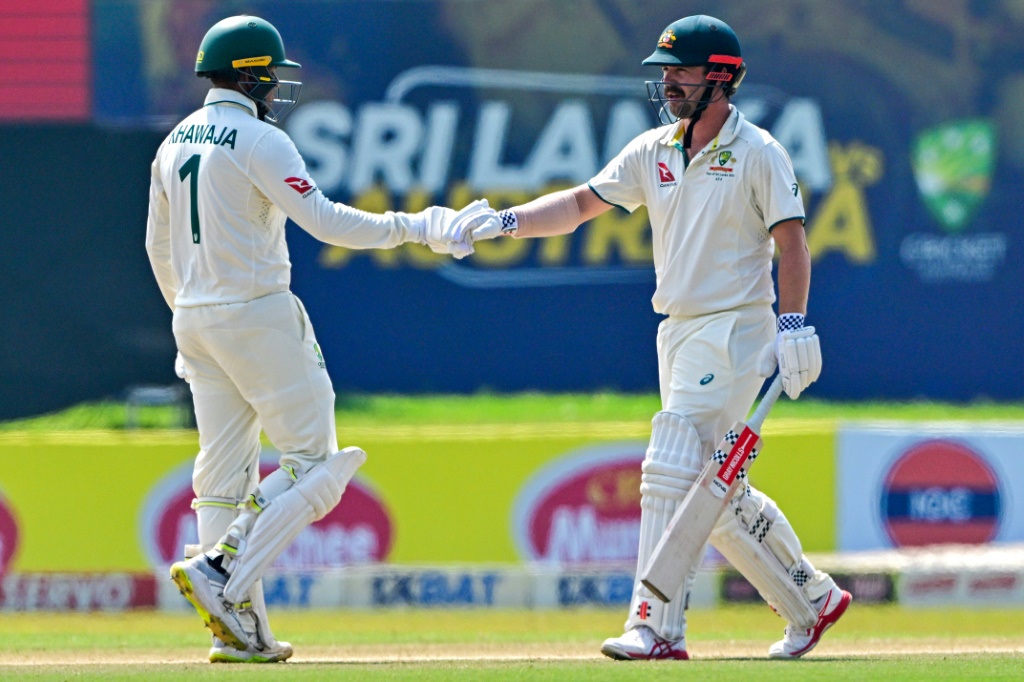 Australia's Usman Khawaja (left) and teammate Travis Head bump fists on the fourth day of the second Test against Sri Lanka in Galle, AFP