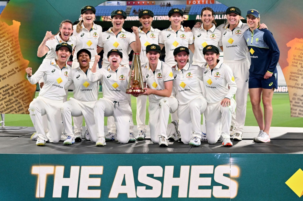 Australia players pose with the trophy after defeating England to complete an Ashes whitewash, AFP