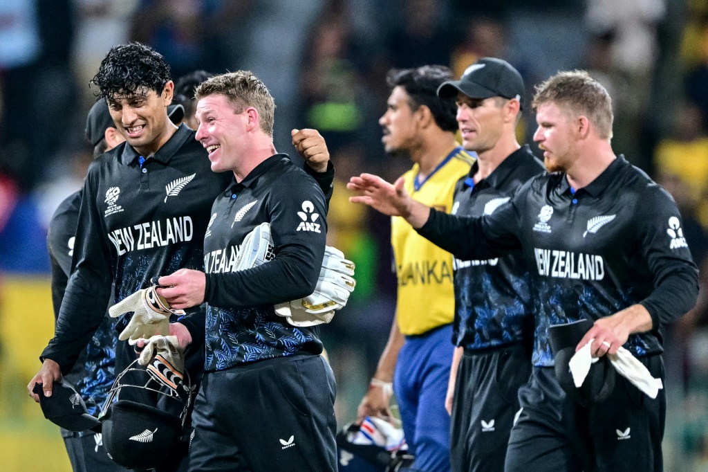 New Zealand's Rachin Ravindra (L) and wicketkeeper Tim Seifert (2L) celebrate their team's win