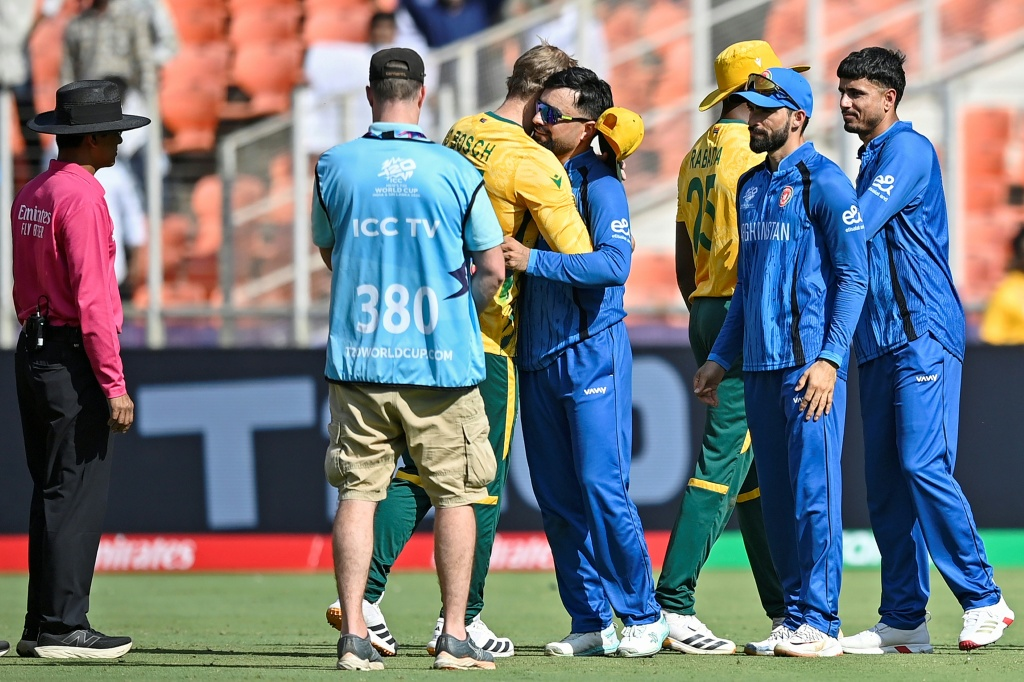 Afghanistan's captain Rashid Khan hugs South Africa's Corbin Bosch