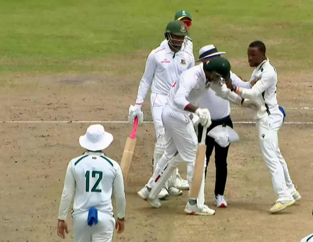 Tshepo Ntuli lands a punch on Ripon Mondol's helmet as umpires try to intervene.