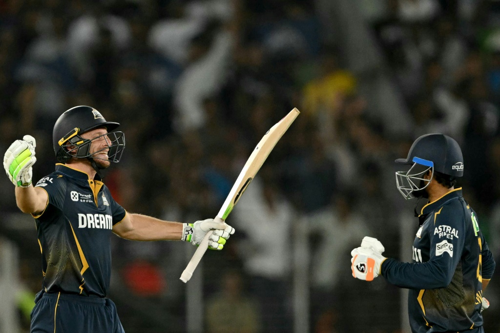 Jos Buttler (L) and Rahul Tewatia celebrate a win over the Delhi Capitals that took Gujarat top of the IPL table