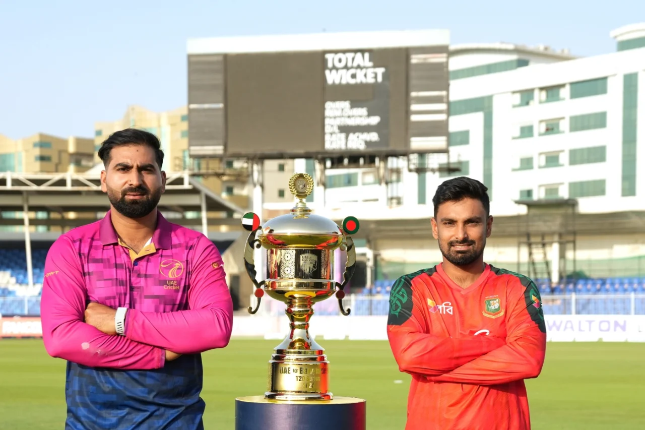 Muhammad Waseem and Litton Das pose with the T20I series trophy