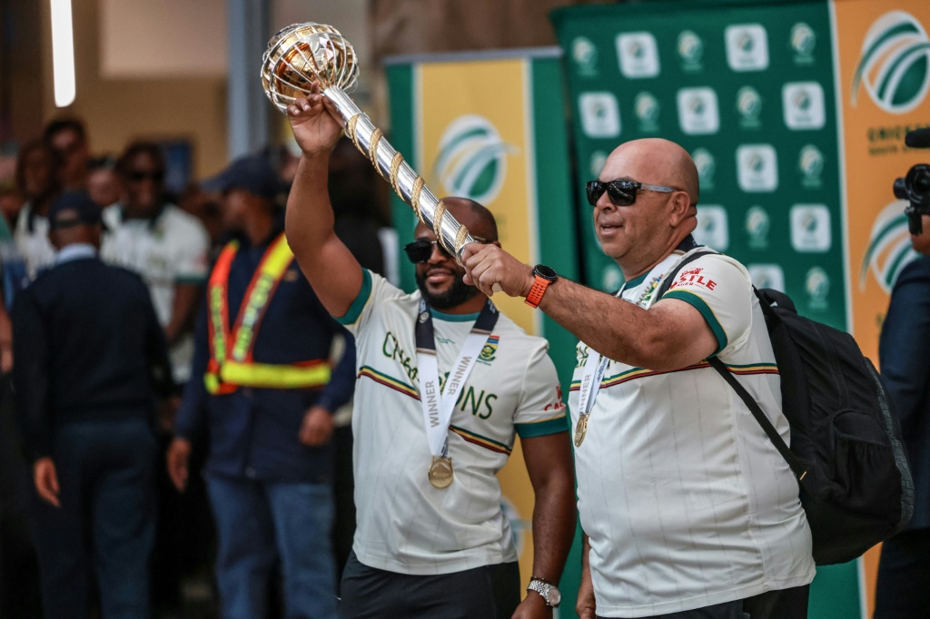 South Africa captain Temba Bavuma (L) and coach Shukri Conrad hold the Mace in Johannesburg