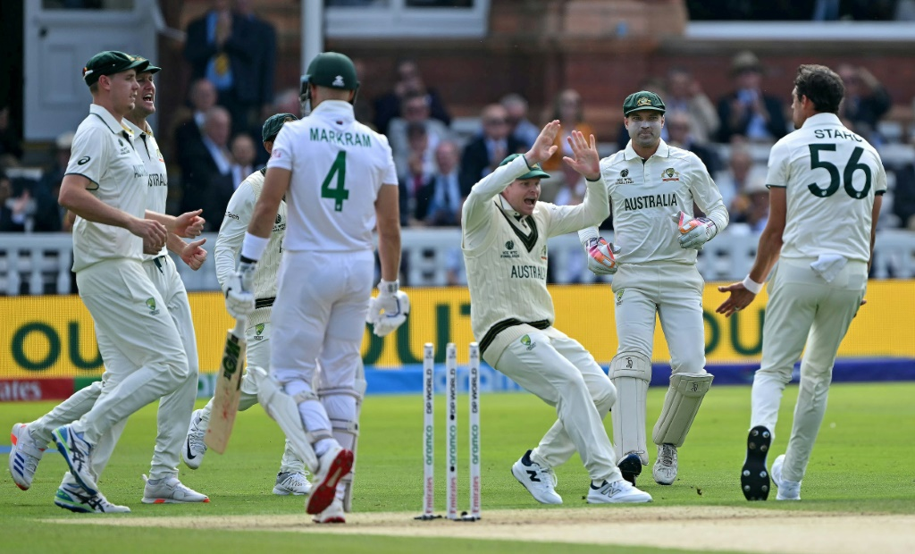 Australia's Mitchell Starc celebrates with Steve Smith (C) after dismissing South Africa's Aiden Markram for a duck on the first day of the World Test Championship final at Lord's